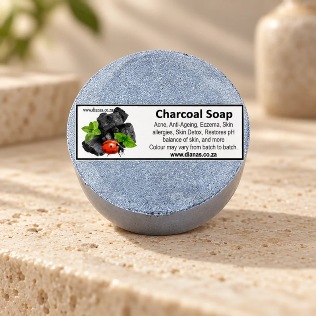 Charcoal Coconut “round” Soap Bar — Diana's product in a warm stone editorial setting